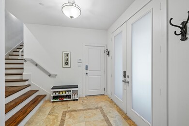 Spacious foyer featuring a large coat closet and the entrance to the 2 car garage.