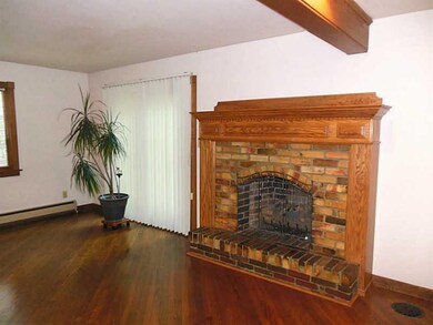 Living Room. Gleaming hardwood floors & gorgeous fireplace in a bright living room.