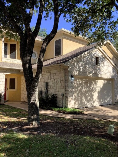 View of front facade with concrete driveway, an a