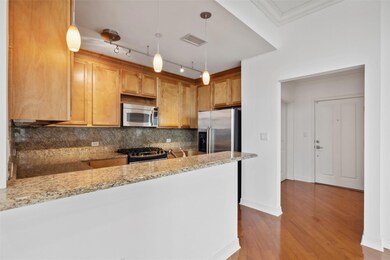 Kitchen featuring light stone countertops, tastefu