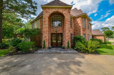The elegant entrance to this home features a circular drive, double doors and two-story entry.