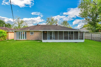 Back yard view of the charming screened in porch, what fun can be had! and look at the bay windows in the breakfast room!