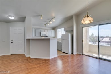 Kitchen featuring white appliances, light wood-typ