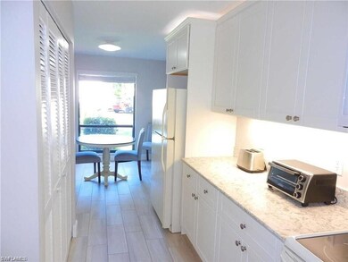 Kitchen featuring white fridge, light stone counte