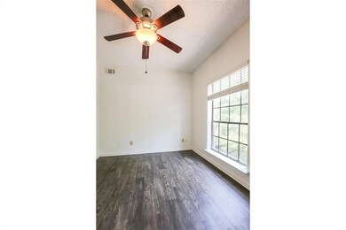 Spare room with ceiling fan, dark wood-style floo
