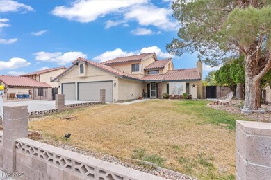 Mediterranean / spanish-style house featuring a tiled roof, stucco siding, an attached garage, and driveway