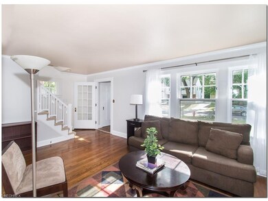 Living room with oak floors & crown mouldings and 