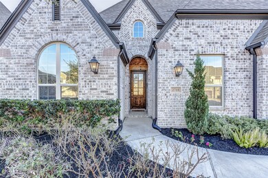 A landscaped pathway leads to the glass door  tallowing natural light to illuminate the front foyer.