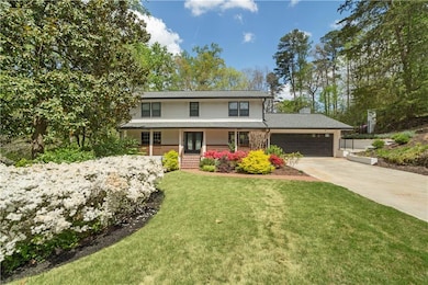 Traditional-style home featuring a front lawn, an 