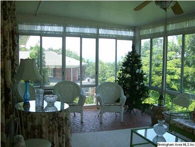 Pretty Sunroom with distant view of mountains.