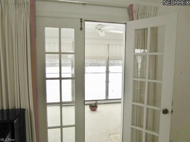 French doors lead to screen porch to enjoy view of