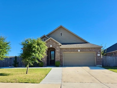 View of front of house featuring brick siding, concrete driveway, and an attached garage