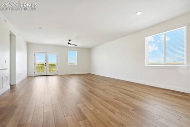 Unfurnished room with french doors, light hardwood