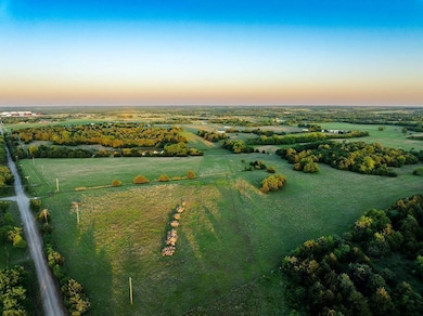 Aerial view at dusk featuring a rural view