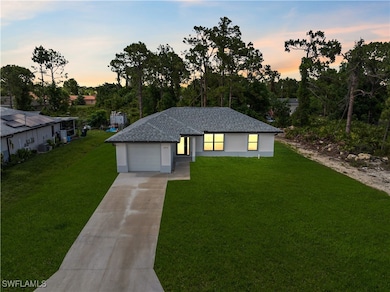 View of front of house featuring a front lawn, con