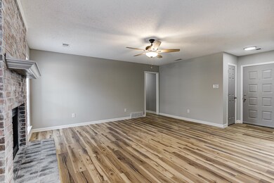 Unfurnished living room featuring baseboards, a ce