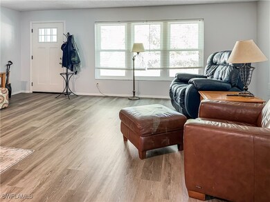 Living area featuring baseboards and wood finished