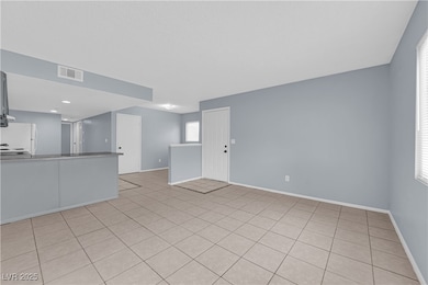 Unfurnished living room with baseboards and visibl