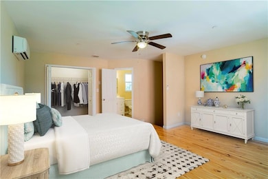 Bedroom featuring a closet, baseboards, light wood