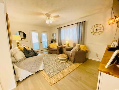 Living room featuring french doors, LVP floors, an