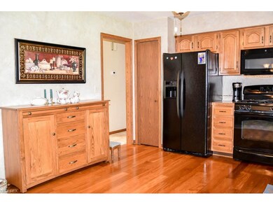 Kitchen has beautiful wood flooring.