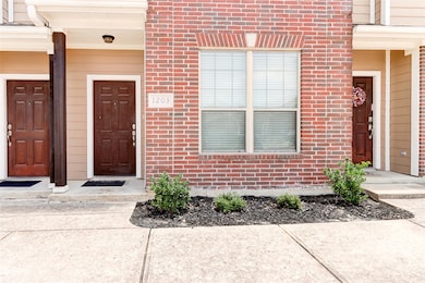 View of exterior entry with brick siding