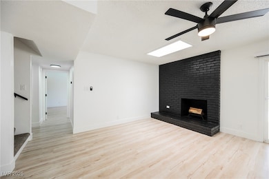 Unfurnished living room featuring a ceiling fan, a