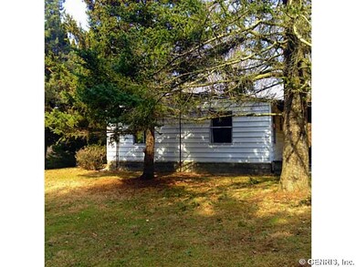Exterior Back. Trees surround the property