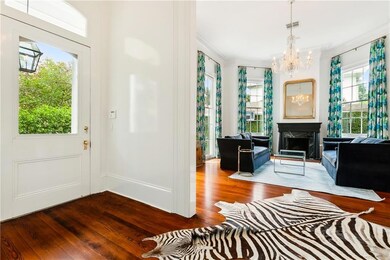 Foyer and formal living room with crystal chandeli