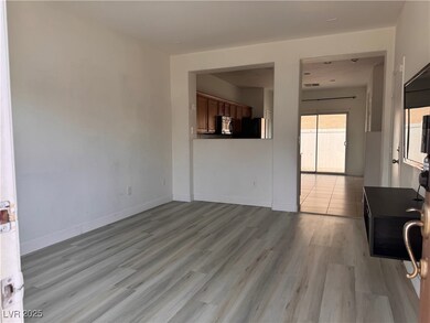 Unfurnished living room with baseboards and light