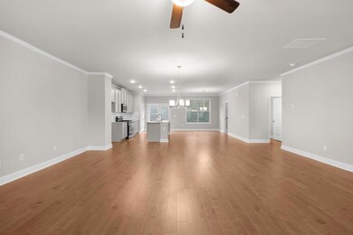 Unfurnished living room featuring crown molding, b