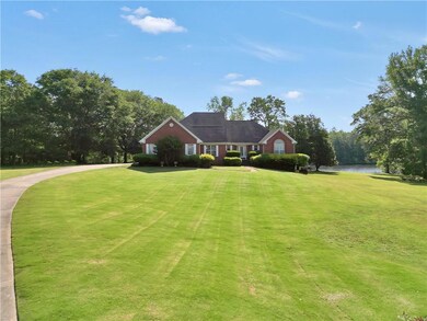 View of front of home with a front lawn and a wate