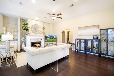 Living room featuring ceiling fan, dark wood-type 