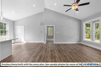 Unfurnished living room featuring high vaulted ceiling, dark wood-style flooring, a ceiling fan, and recessed lighting