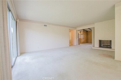 Dual fireplace between living room and den.