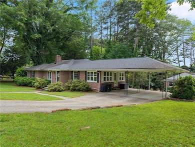 Ranch-style house featuring brick siding, driveway