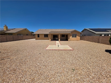 Rear view of house with a patio area, a fenced bac