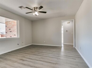 Empty room with a textured ceiling, light wood-typ