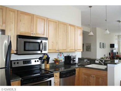 The kitchen has maple cabinets, stainless steel ap