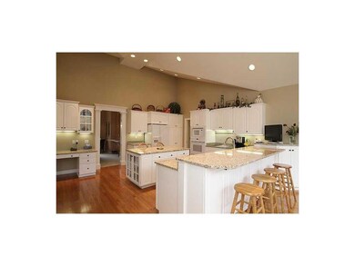Kitchen. A vaulted ceiling makes the room feel eve
