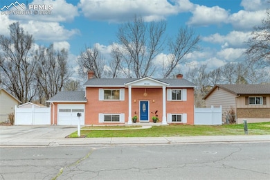 View of front of home featuring a chimney, fence, 