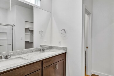 Bathroom featuring double vanity, a shower, and a 