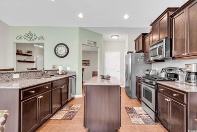 Kitchen with dark brown cabinetry, appliances with