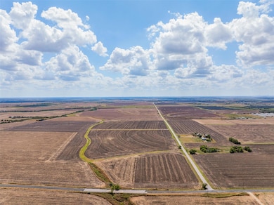 Aerial view of sparsely populated area with large plots for crops