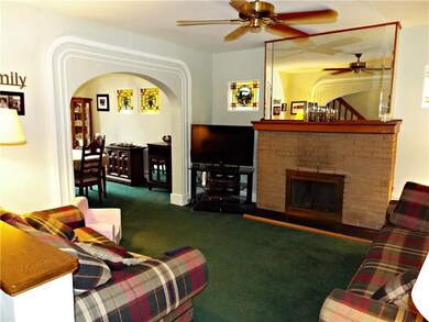 Living Room with gas fireplace and large mirror ov