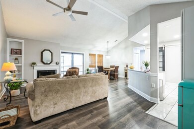Living area with a barn door, lofted ceiling, woo