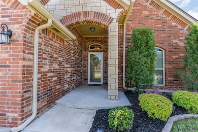 Doorway to property featuring brick siding