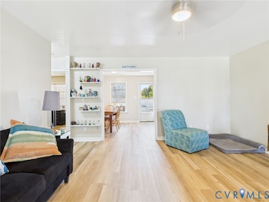 Living area featuring light wood-style floors and ceiling fan