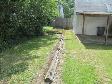 Rear view of yard. Garden area behind garage. Adde