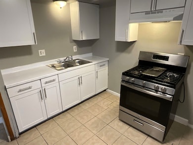 Kitchen featuring white cabinets, light countertop